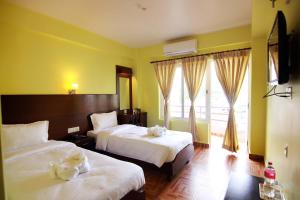 My Hotel Pvt Ltd tesisinde bir odada yatak veya yataklar