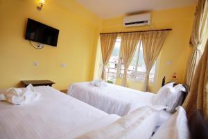 My Hotel Pvt Ltd tesisinde bir odada yatak veya yataklar