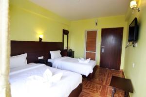 My Hotel Pvt Ltd tesisinde bir odada yatak veya yataklar