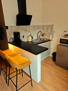 a kitchen with a black counter and a sink at Brussels Cozy Studio in Brussels