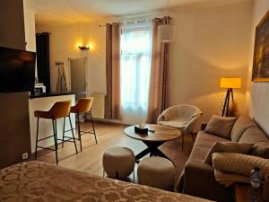 a living room with a couch and a table at Brussels Cozy Studio in Brussels