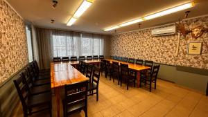 a dining room with wooden tables and chairs at Suurlahe Guesthouse in Kuressaare