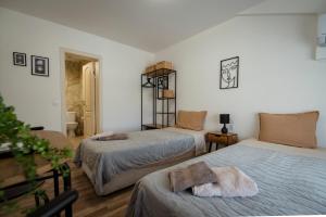 a bedroom with two beds with towels on them at Къща за гости ЕМА in Vetren Dol +35 photos