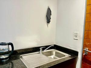 a sink in a kitchen with a counter top at High Rise Haven 2 in Johannesburg +26 photos