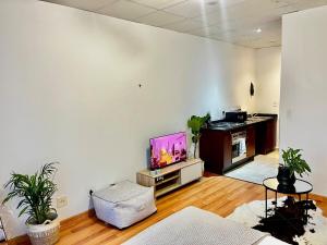 a living room with a flat screen tv on a wall at High Rise Haven 2 in Johannesburg