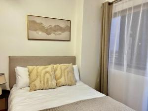 a bed in a room with a window and a bed sidx sidx sidx at High Rise Haven 2 in Johannesburg