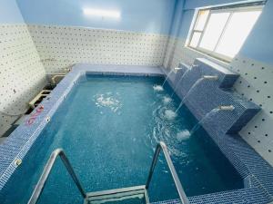 a large pool of water in a room at Tulsi Garden- Near Prem Mandir Vrindavan in Vrindāvan