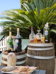 a table with wine bottles and a plate of food at Appartement Sole e Mare in Furiani