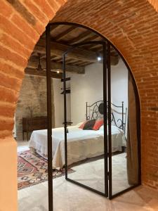 a bedroom with a bed in a brick wall at Appartamento Monache in Lucignano