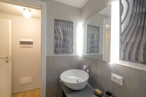 a bathroom with a sink and a mirror at Casa degli Specchi- Duplex in Arona city center - By Guestaly in Arona +25 photos