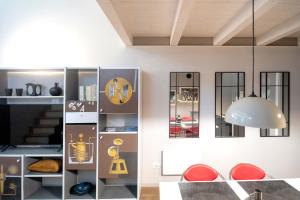 a living room with a clock on the wall at Casa degli Specchi- Duplex in Arona city center - By Guestaly in Arona