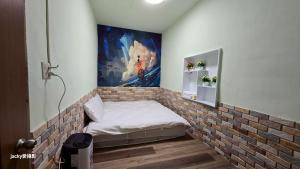 a room with a brick wall with a bed in it at 清境77窩House-包棟包層民宿 in Ren'ai