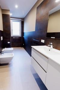 a bathroom with a sink and a toilet at Residenza CONCORDIA in Sondrio