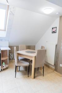 a dining room with a table and chairs at Katyca Apartman in Balatonfüred
