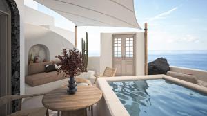 a villa with a jacuzzi tub in a living room at You and Me Suites Oia in Oia