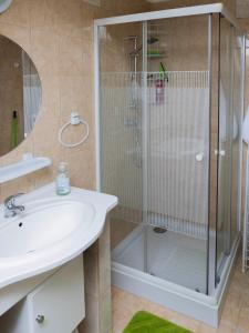 a bathroom with a shower and a sink at Katyca Apartman in Balatonfüred