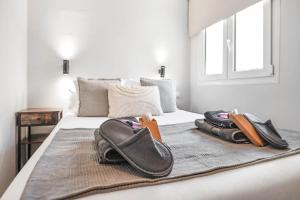 a bed with a pile of towels and shoes on it at Merced luxury in Málaga