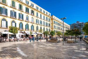 a large building with people walking around in a street at Merced luxury in Málaga