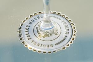 a glass wine glass with the department of immigration logo on it at Reginna Palace Hotel in Maiori +79 photos