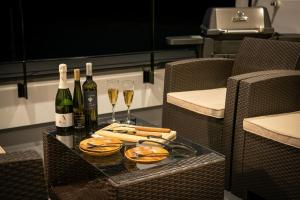 a table with two glasses of wine and wine bottles at Seven Saunas Village in Arao