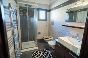 a bathroom with a shower and a toilet and a sink at Suite del Corso in Ficarazzi +43 photos