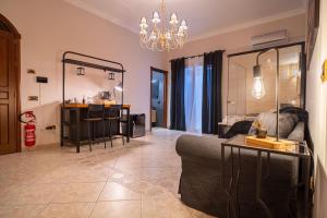a living room with a couch and a chandelier at Suite del Corso in Ficarazzi