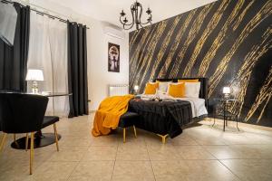a bedroom with a bed with a yellow blanket on it at Suite del Corso in Ficarazzi