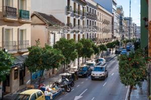 a city street with cars parked on the side of the road at VICTORIA 75 LUXURY in Málaga