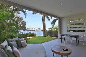 a living room with a white couch and a view of the water at Morea SXM in Simpson Bay