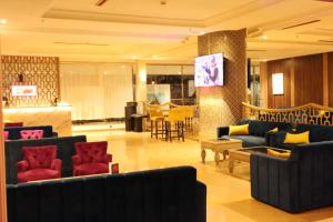 a lobby with couches and chairs and a bar at Royal Mirage Agadir in Agadir
