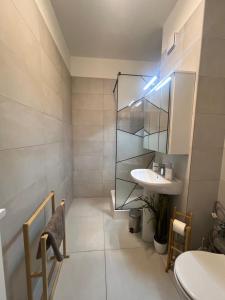 a bathroom with a sink and a mirror at RULU Studio Plaza Mall in Bucharest +11 photos