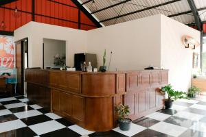 a bar in a room with a checkered floor at Hau Batu Karas in Batukaras