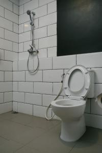 a bathroom with a toilet with a shower in it at Hau Batu Karas in Batukaras +31 photos