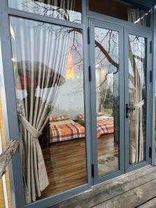 a sliding glass door with a view of a bedroom at Vuon Hong Le Phuc-Cau Dat Glamping Retreat Da Lat in Ấp Trạm Hành