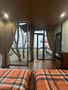 a bedroom with a bed and a view of the ocean at Vuon Hong Le Phuc-Cau Dat Glamping Retreat Da Lat in Ấp Trạm Hành +105 photos