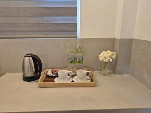 a tray with two cups and two bottles of water at Hiru Villa Tangalle in Tangalle