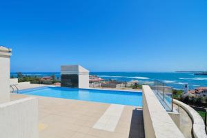 a swimming pool with a view of the ocean at Palm Terrace in Mombasa