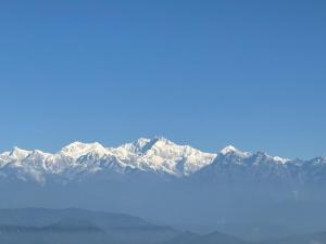 a view of a mountain range with snow covered mountains at Bunk Stays in Darjeeling