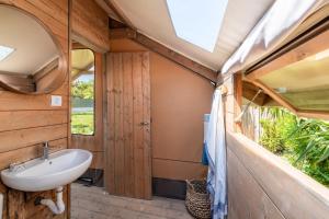 a bathroom in a tiny house with a sink at Procida Camp & Resort - Ciraccio in Procida