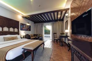a bedroom with a large bed and a television at Chandragiri Hills Resort Kathmandu-Luxury in the Clouds in Thānkot