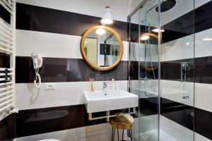 a bathroom with a sink and a mirror at Vatican Chic B&B in Rome