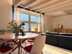 a living room with a table and chairs and a couch at Urlaubsschmiede Mosel in Traben-Trarbach