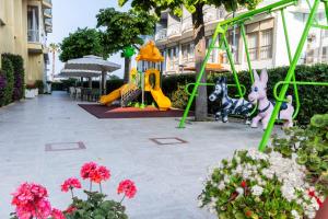 a playground with a slide and a play equipment at Hotel President in Alba Adriatica