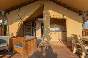 a tent with a table and chairs in it at Procida Camp & Resort - Ciraccio in Procida