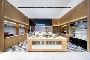 a kitchen with a counter with food on it at Echarm International Hotel Guangzhou Huangpu Flagship Shuixi Subway Station Branch - Free Deliver Service to Guangzhou Baiyun International Airport & Free Deliver Service to Canton Fair Complex During Canton Fair Period in Guangzhou