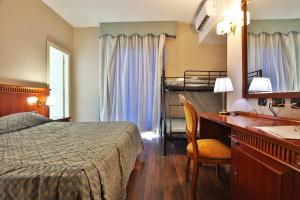 a hotel room with a desk and a bed and bunk beds at Hotel La Fayette Giugliano Licola in Giugliano in Campania +163 photos