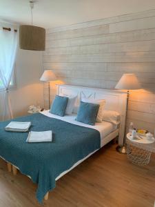 a bedroom with a large bed with two towels on it at Chambres d'Hôtes Villa La Louisiane in Arès +39 photos