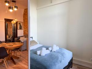 a bedroom and a living room with a bed and a table at Zapisane w Cegle by LibertaRent in Świdnica +7 photos