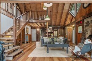 a living room with a staircase and a couch at Rustic 3-Bed Retreat in Springbrook in Springbrook