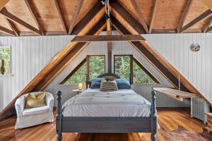 a bedroom with a bed in a attic at Rustic 3-Bed Retreat in Springbrook in Springbrook